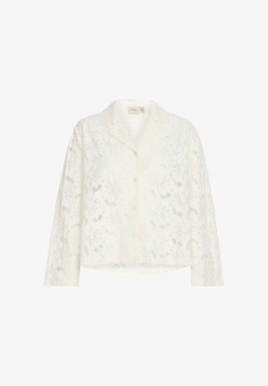 Balta nėrinių marškinėliai su ilgomis rankovėmis, gėlių raštu ir laisvu siluetu. Turi apykaklę ir šiek tiek išlenktą apatinę dalį.