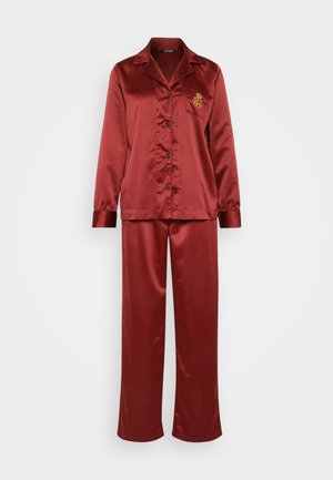 Red satin pajama set featuring a long-sleeve button-up shirt with a chest pocket and matching pants. Gold embroidered logo detail on shirt.