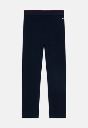 Mallas largas azul marino con cintura elástica y una pequeña etiqueta con logo cerca de la parte superior derecha.