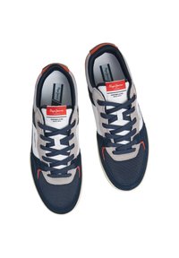 Navy and gray sneakers with mesh and suede textures, featuring white accents, a red logo tag, and black laces. Padded collar for comfort.