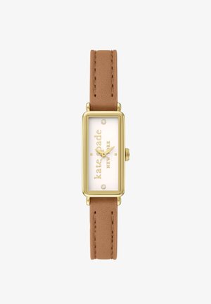 Montre rectangulaire dorée avec un cadran blanc et un bracelet en cuir marron. Présente trois index argentés et le nom de la marque en doré.
