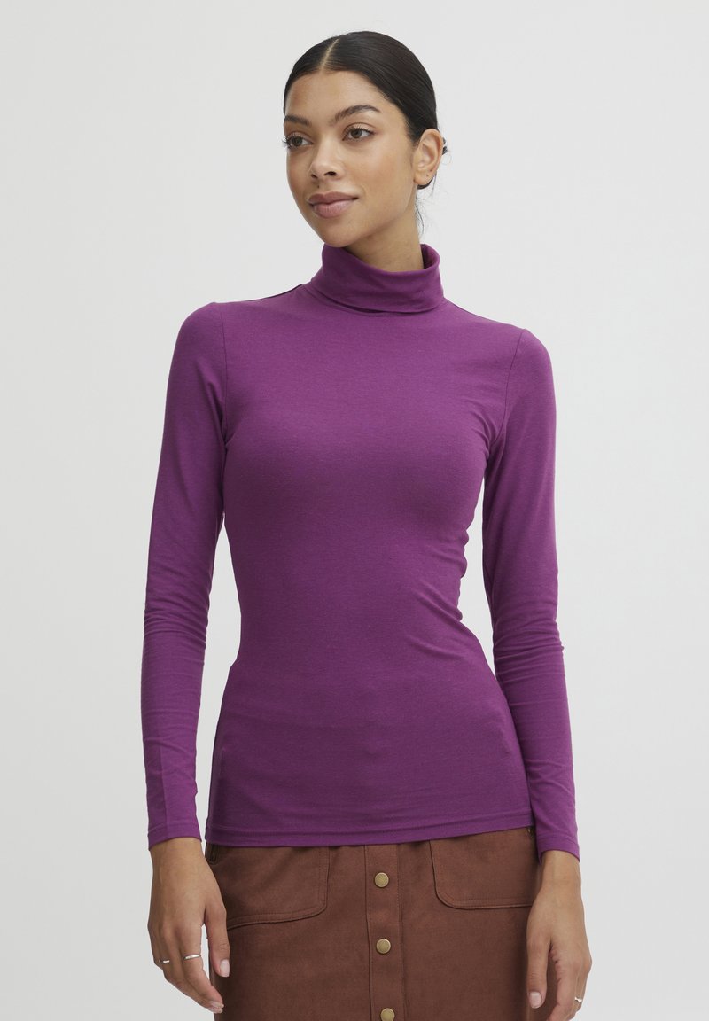 Lilla langærmet turtleneck skjorte i et let, strækbart stof; tætsiddende silhuet med glat tekstur og høj halsudskæring.