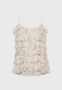 Blouse légère et superposée avec des bretelles spaghetti. Présente un imprimé floral dans des tons beige doux et pêche clair. Tissu texturé avec un design à volants.