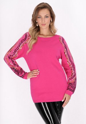 Roze gebreide trui met lange mouwen, voorzien van een golvend decoratie van sequins in zwart, goud en roze. Soepele textuur, losse pasvorm en geribde manchetten.