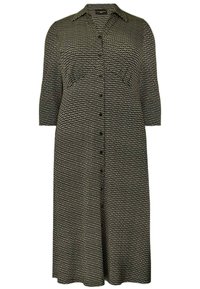 Mustat ja valkoiset kuviot omaava mekko, jossa on napitettava etuosa, teräväkauluksinen design ja kolme neljännestä hihaa. Kevyt kangas, polven mittainen malli.