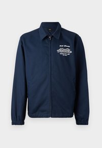 Navy blue zip-up jacket made of smooth fabric, featuring elastic cuffs, side pockets, and white graphic text on the left chest.