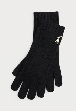 Black knitted gloves with ribbed cuffs, featuring a cable design and a small gold logo accent. Made of soft, textured material.