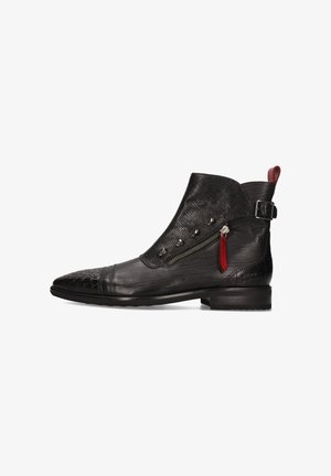 Black ankle boots with textured leather, pointed toe, zipper detailing, red accent, side buckle, and low heel. Distinctive pattern on toe cap.