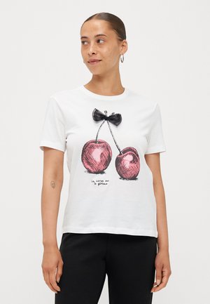 White cotton t-shirt featuring a graphic of two pink cherries with a black bow above, and the text "la cerise sur le gâteau" beneath.