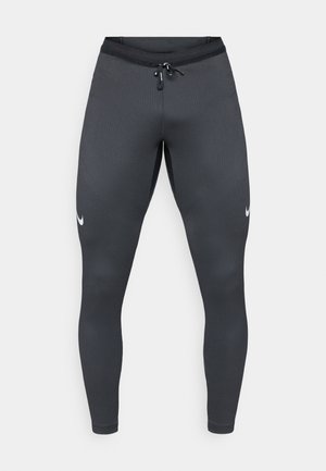 Halli sportlikud retuusid, mis on valmistatud venivast kangast, omavad lähedast istuvust, ribakudu ja väikest valget Nike logo vasakul jalal.