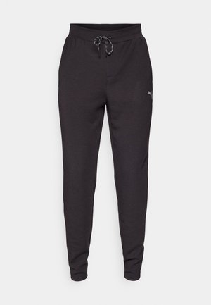 Schwarze Jogginghosen aus weichem Stoff, mit elastischem Taillenbund und Kordelzug, seitlichen Taschen und einem kleinen Logo auf dem linken Oberschenkel.