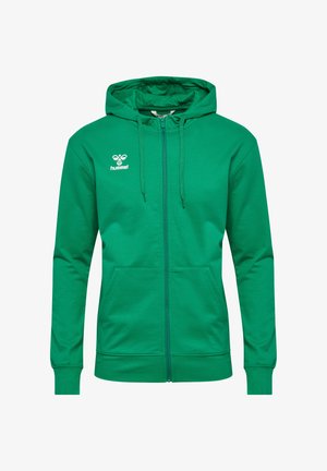 Sweat à capuche zippé vert en coton, avec capuche, cordons de serrage et poches avant. Comprend un logo blanc sur la poitrine.