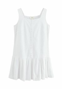 Robe en lin blanc avec un décolleté carré, des bretelles ajustables et un ourlet à volants évasé. Présente un devant à boutons avec de petits boutons.