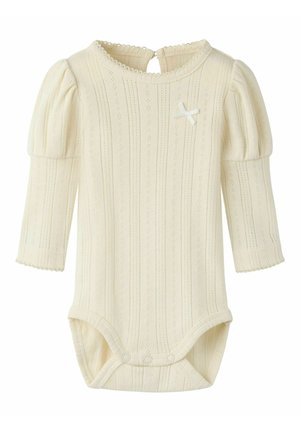 Cream-colored long-sleeve baby onesie with puffed shoulders, eyelet knit pattern, back button closure, and small decorative bow on chest.