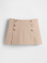 Beige bomullskjørt med rett snitt, med fire store brune knapper på venstre side og en flat kant nederst.