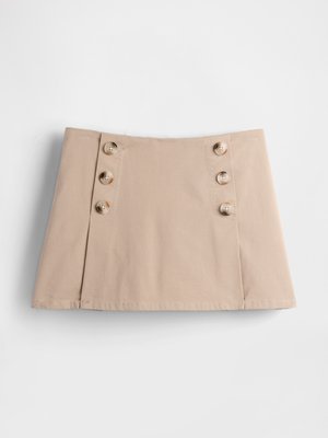 Beige cotton skirt with a straight cut, featuring four large brown buttons on the left side and a flat hem at the bottom.