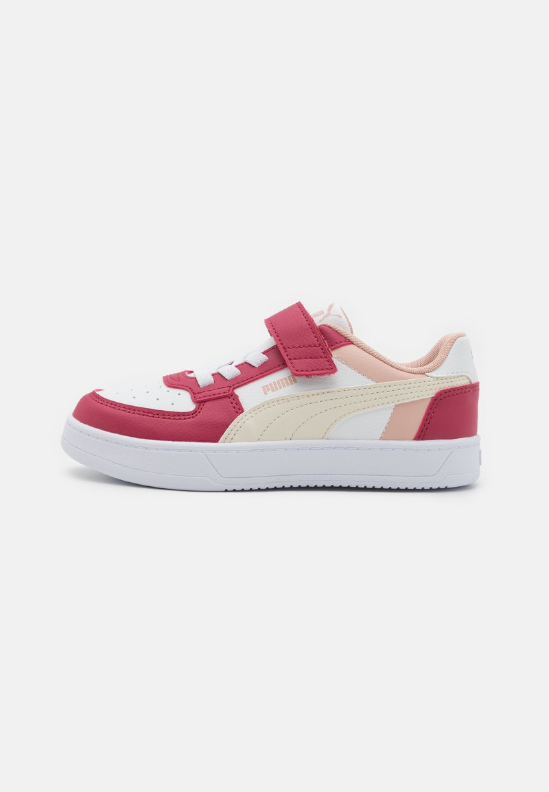 Sneakers with a white, red, and pink leather upper, textured accents, a white sole, and a Velcro strap for easy adjustment.