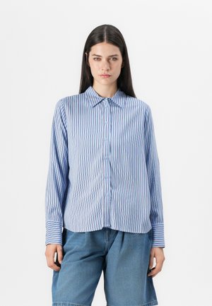 Light blue striped shirt with vertical lines, button-down design, long sleeves, and cuffed wrists. Smooth texture. Paired with denim shorts.