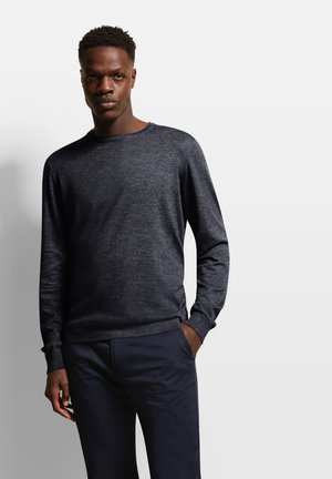 Dark grey long-sleeve sweatshirt made of soft knit fabric with a crew neckline and ribbed cuffs, paired with navy blue pants.