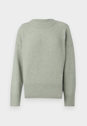 Light green knitted sweater with a ribbed round neck and hem. Features dropped shoulders and long sleeves. Soft texture with subtle sheen.