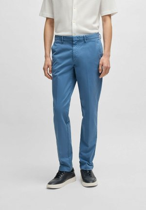 Blue lightweight trousers with a smooth texture, straight cut, elastic waistband, and side pockets, paired with black sneakers.
