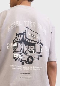 Gray cotton t-shirt featuring a black graphic of a food truck with Asian lettering, a banner, and text about operating hours and menu.