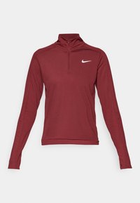 Prążkowany, burgundowy top z długim rękawem i kołnierzem z pół-zamkiem, z małym białym logo Nike na lewej piersi. Miękki, elastyczny materiał.
