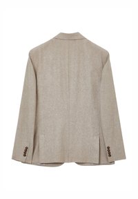 Blazer beige con un tessuto strutturato, una feritoia singola sul retro e bottoni decorativi sulle maniche. Design classico con risvolto, non foderato.