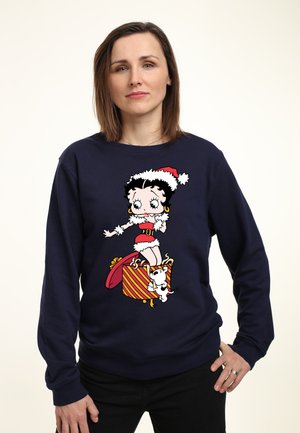 Marineblå sweatshirt med et legende Betty Boop design og røde accenter, prydet med en legesyg hund, der fremhæver et festligt juletema.