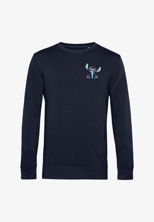 Maglietta a maniche lunghe blu navy con scollo rotondo, con un piccolo personaggio dei cartoni animati colorato sul petto in alto a sinistra.