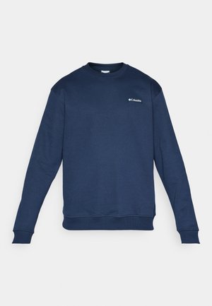 Mornarsko modra Columbia pulover s dolgimi rokavi in ribanimi manšetami ter robom, prikazan na enakomernem belem ozadju.