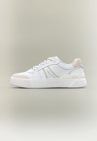 White leather sneaker with beige suede accents, featuring a textured rubber sole, lace-up front, and minimalistic design elements.