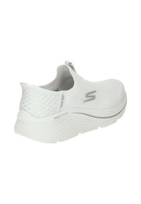 White slip-on sneaker with a textured mesh upper, round toe, and cushioned sole featuring "MAX CUSHION" detail in gray. Lightweight design.