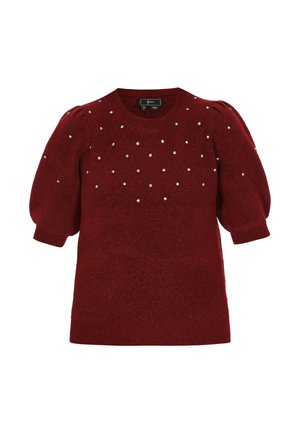 Piros kötött pulóver rövid puffos ujjal. Kis dekoratív ezüst díszekkel rendelkezik. Kerek nyakkivágással és bordás szegéllyel.