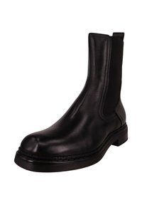 Czarny skórzany botek za kostkę z elastycznymi panelami po bokach, okrągłym noskiem i masywną gumową podeszwą. Posiada przeszycia wokół podeszwy.