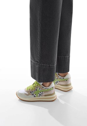 Multicolored sneaker with a mix of suede and mesh. Features white, green, and leopard print accents, with a textured sole and laces.