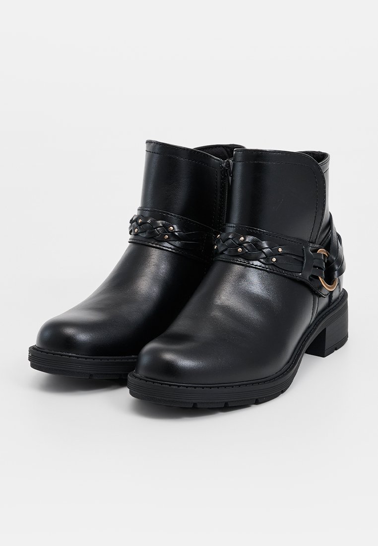 Stivaletti in pelle nera con una cintura intrecciata e dettagli in metallo. Tacco alto e suola in gomma testurizzata. Zip laterale per una facile vestibilità.