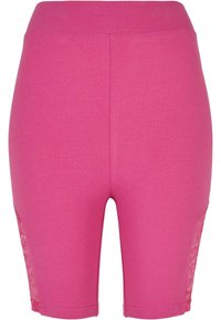 Pantalones cortos de bicicleta de mezcla de algodón en color rosa con una textura suave, que cuentan con detalles de encaje en los lados y una cinturilla elástica.