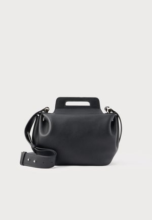 Geantă de mână neagră din piele cu mâner integrat și curea de umăr detașabilă și reglabilă pe un fundal simplu alb.