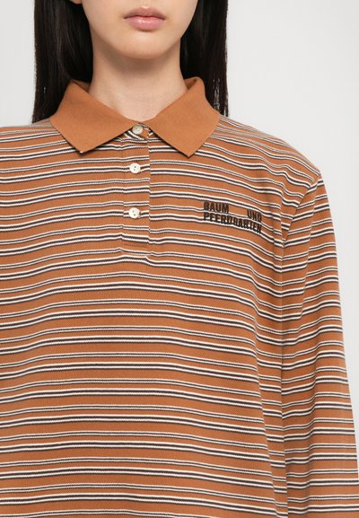 Striped polo shirt in brown, featuring white and black lines, a soft collar, and three-button placket. Embroidered text on the chest.