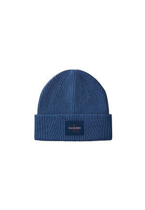 Blue ribbed knit beanie hat with a folded cuff featuring a Calvin Klein logo patch in the center front.