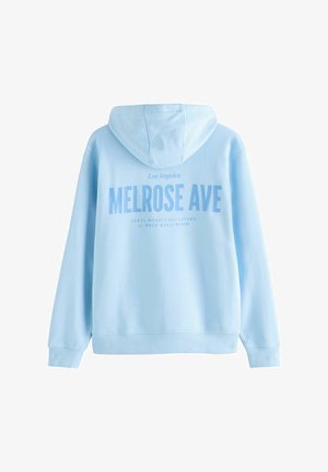 Svetlo modra kapuca s vezalko. Na hrbtni strani je v debelem tisku napis "MELROSE AVE", mehka tkanina z rebrastimi manšitami in robom.