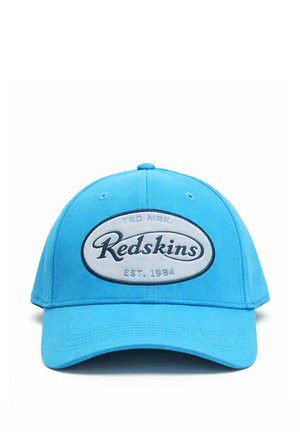 Casquette de baseball bleu vif avec un patch ovale blanc à l'avant affichant "Redskins" en écriture noire et "EST. 1984" en dessous.