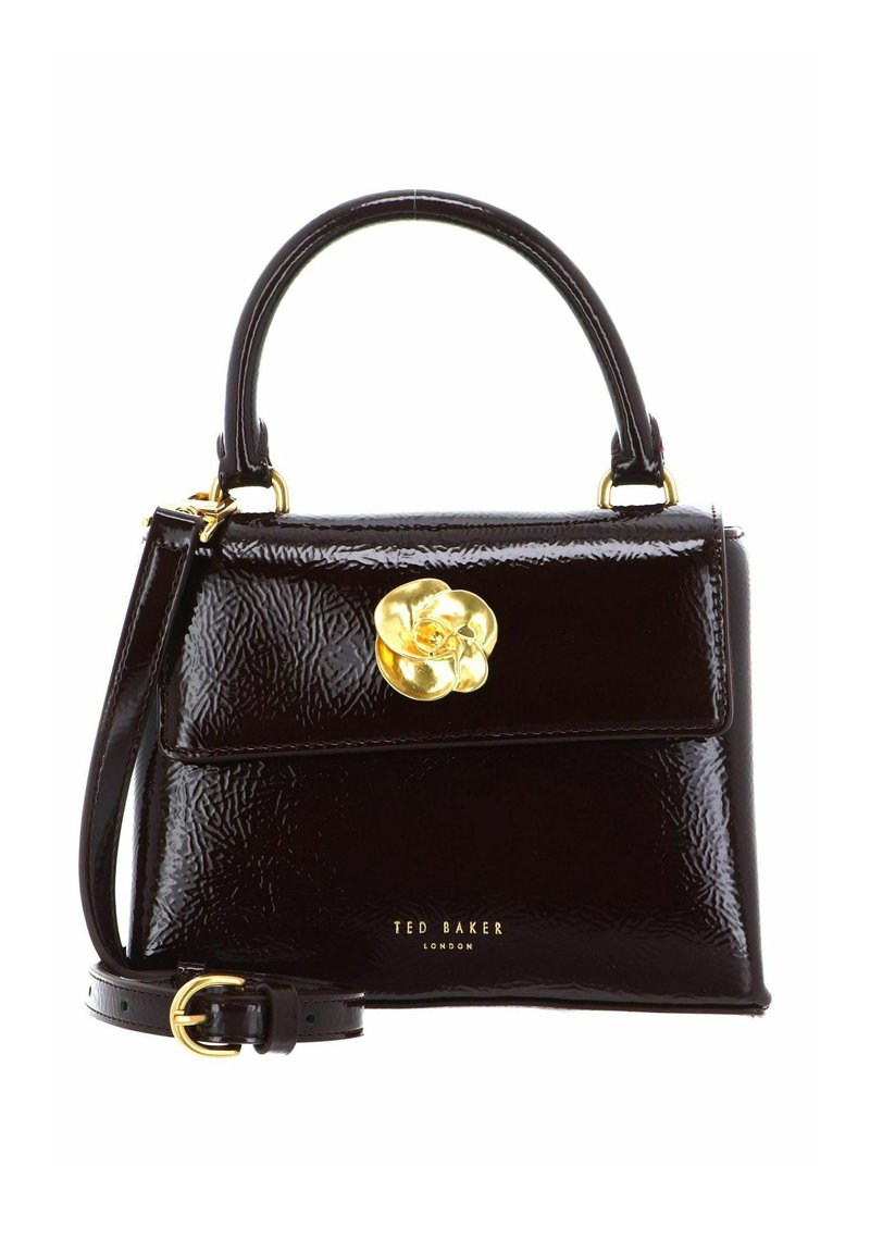 Sac à main en cuir verni noir au design structuré, avec une poignée incurvée, une bandoulière amovible et un fermoir fleur doré.