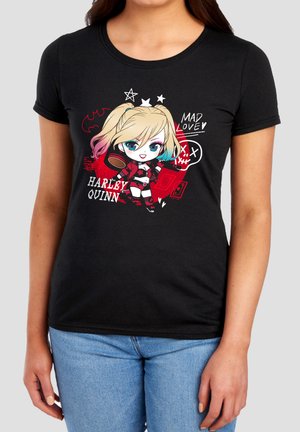 Woman wearing black T-shirt with colorful chibi Harley Quinn holding a mallet, surrounded by stars, hearts, and text "MAD LOVE" and "HARLEY QUINN."