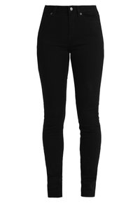 Jeans skinny negros de denim, con un diseño ajustado, cintura alta, cierre de botón y estilo tradicional de cinco bolsillos.