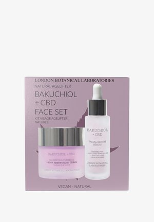 Bakuchiol + CBD face set in a purple box includes a glass dropper bottle serum and a glass jar night cream with silver accents.