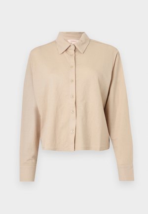 Beige long-sleeve cropped shirt with collar and front button closure, made of soft, lightweight fabric.