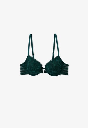 Dark green lace bra with decorative stitching, underwire support, adjustable straps, and a hook closure at the back.