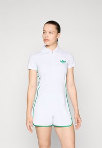White romper with a zip front, green trim, and collar. Features a small green logo on the left chest. Streamlined design and smooth texture.